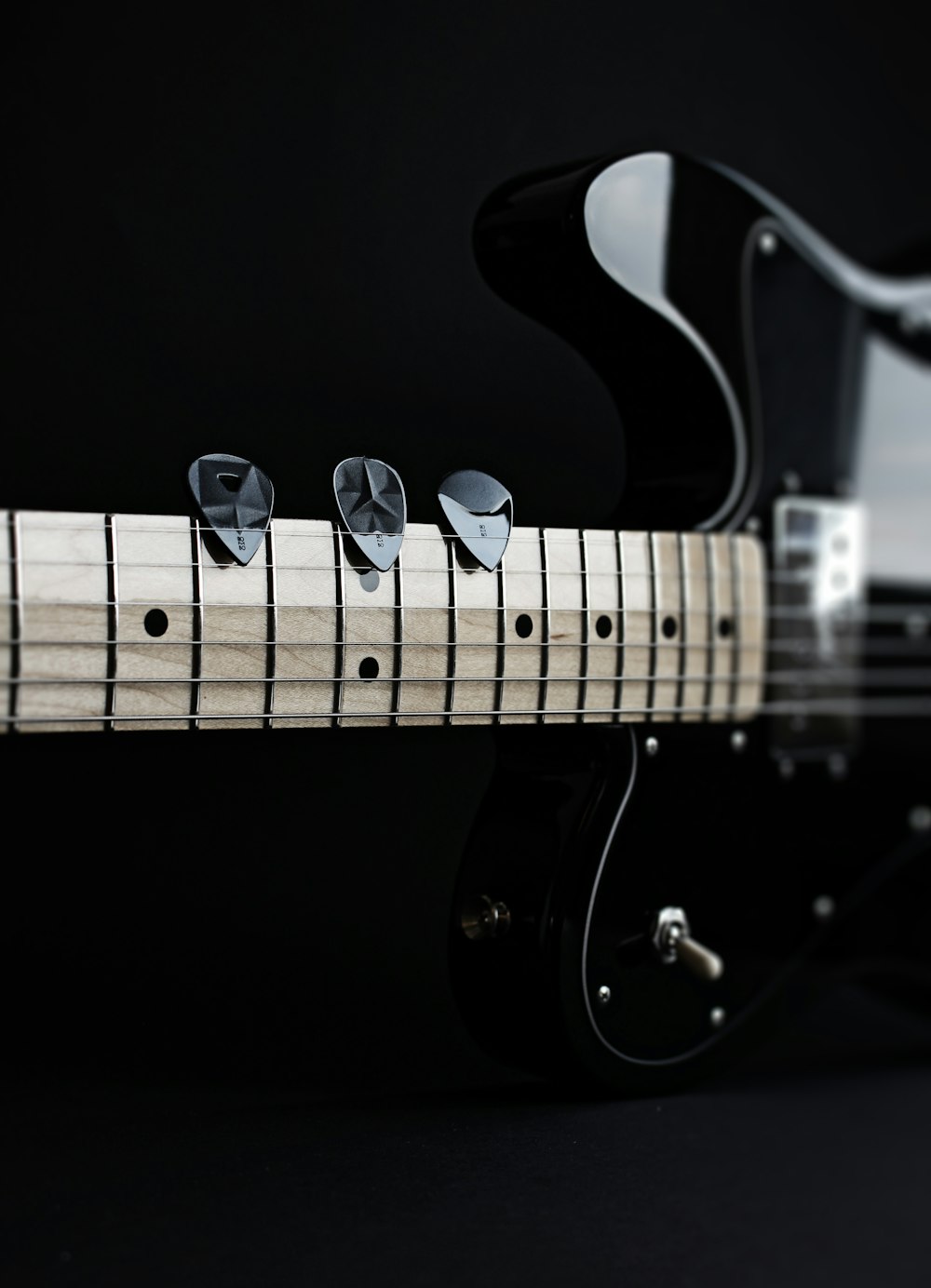 a close up of a black electric guitar
