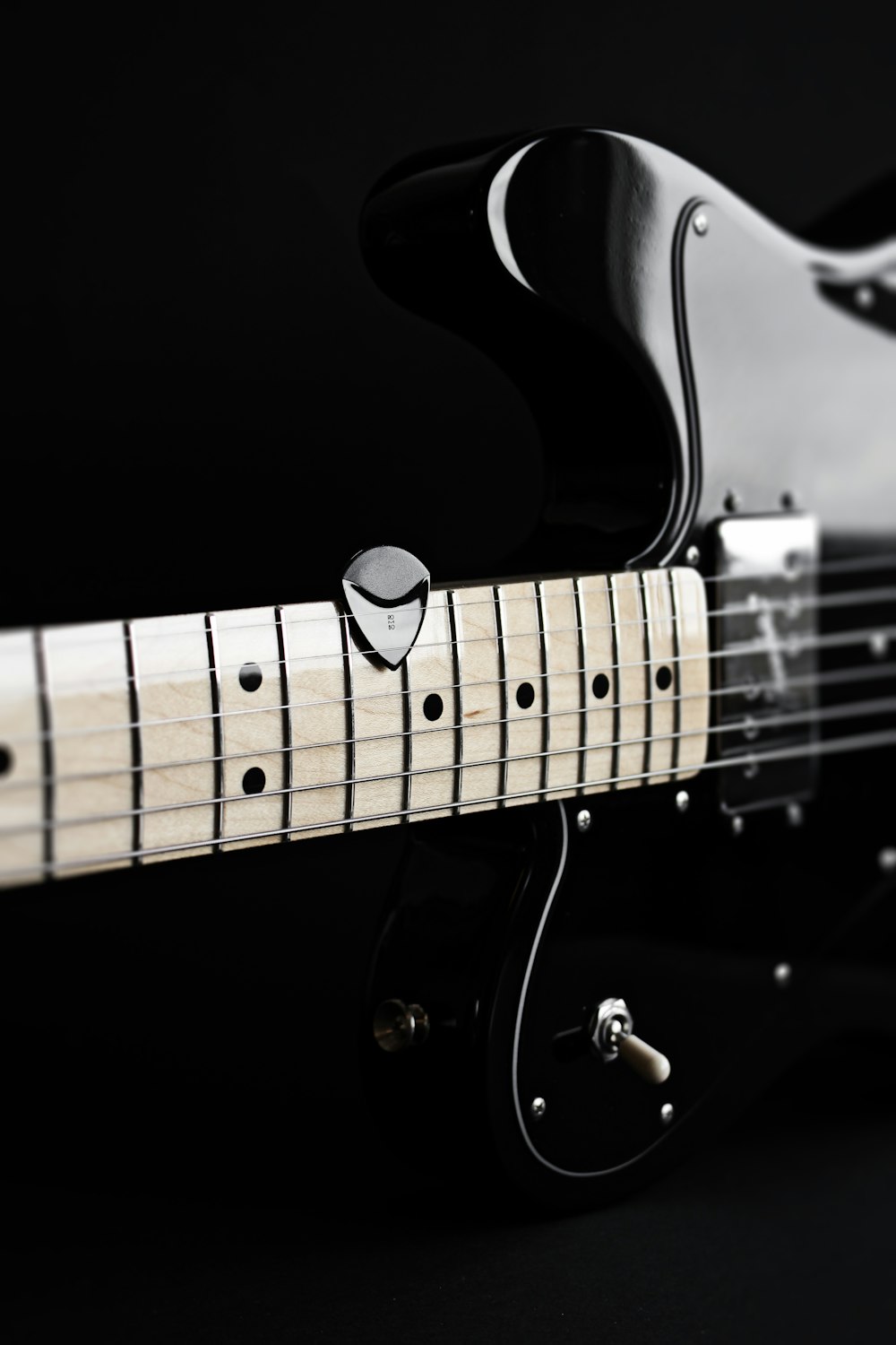 a close up of a black electric guitar