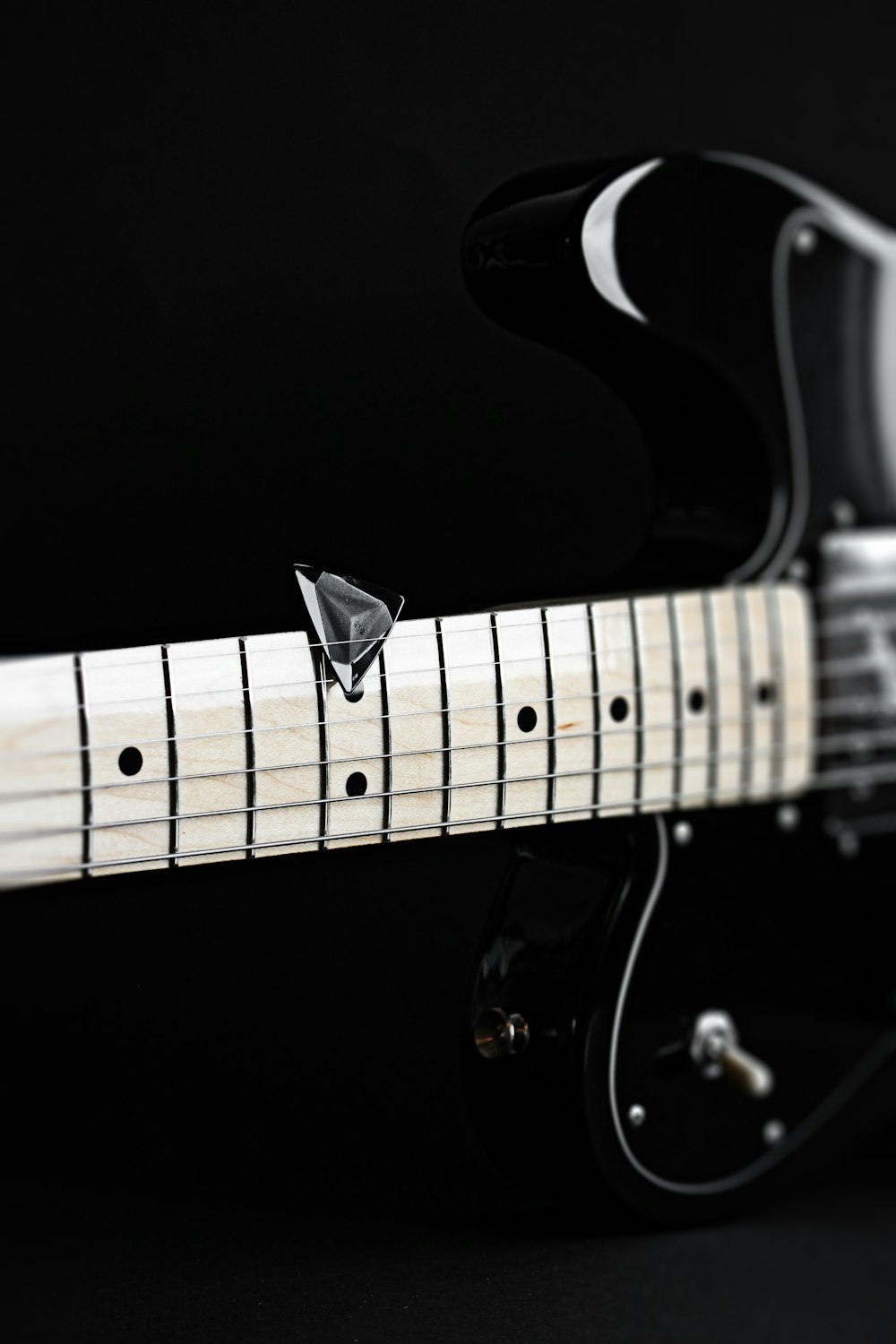 a close up of a black and white guitar