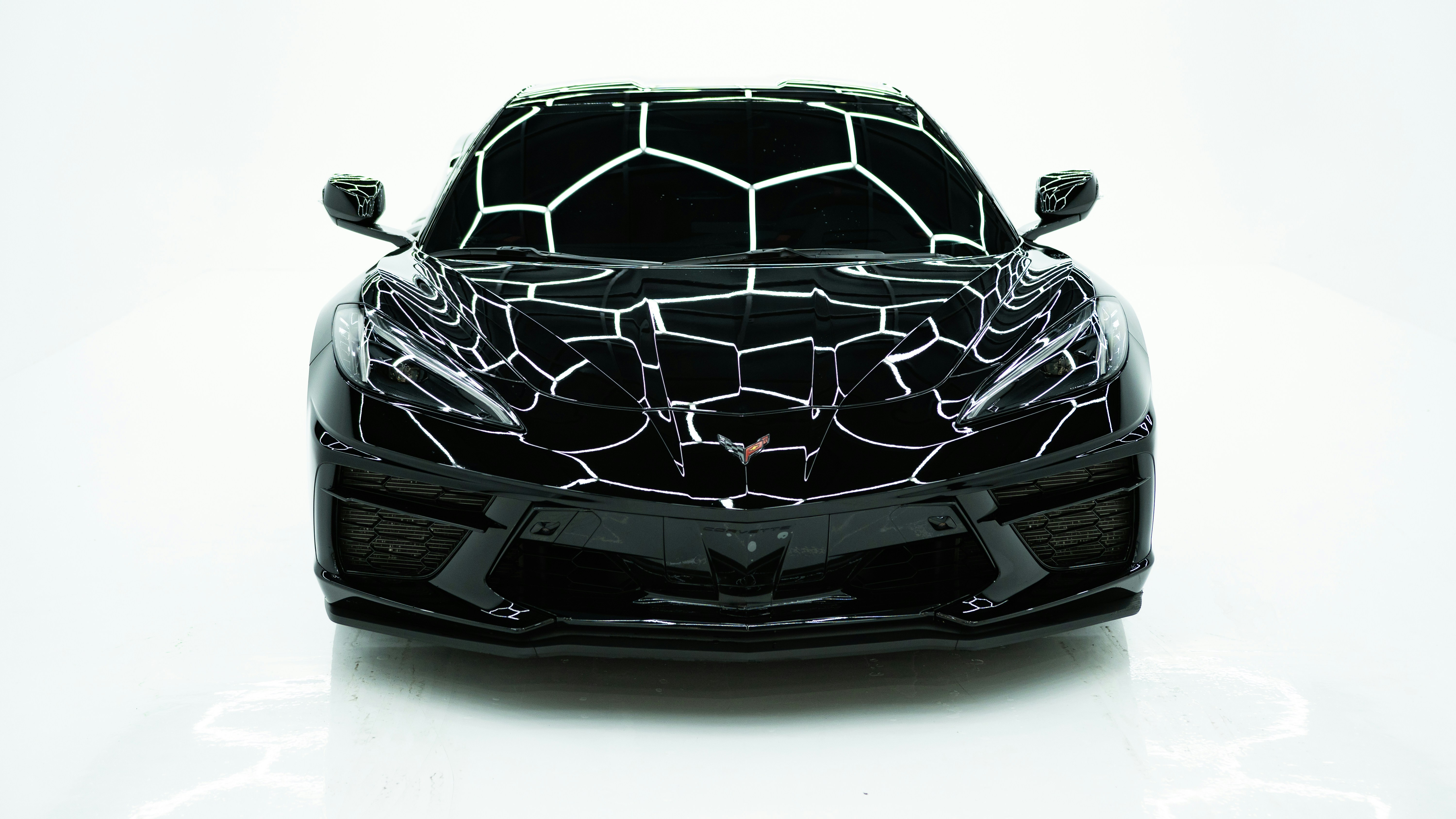 a black sports car with a giraffe pattern on it