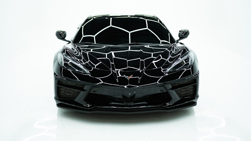 a black sports car with a giraffe pattern on it