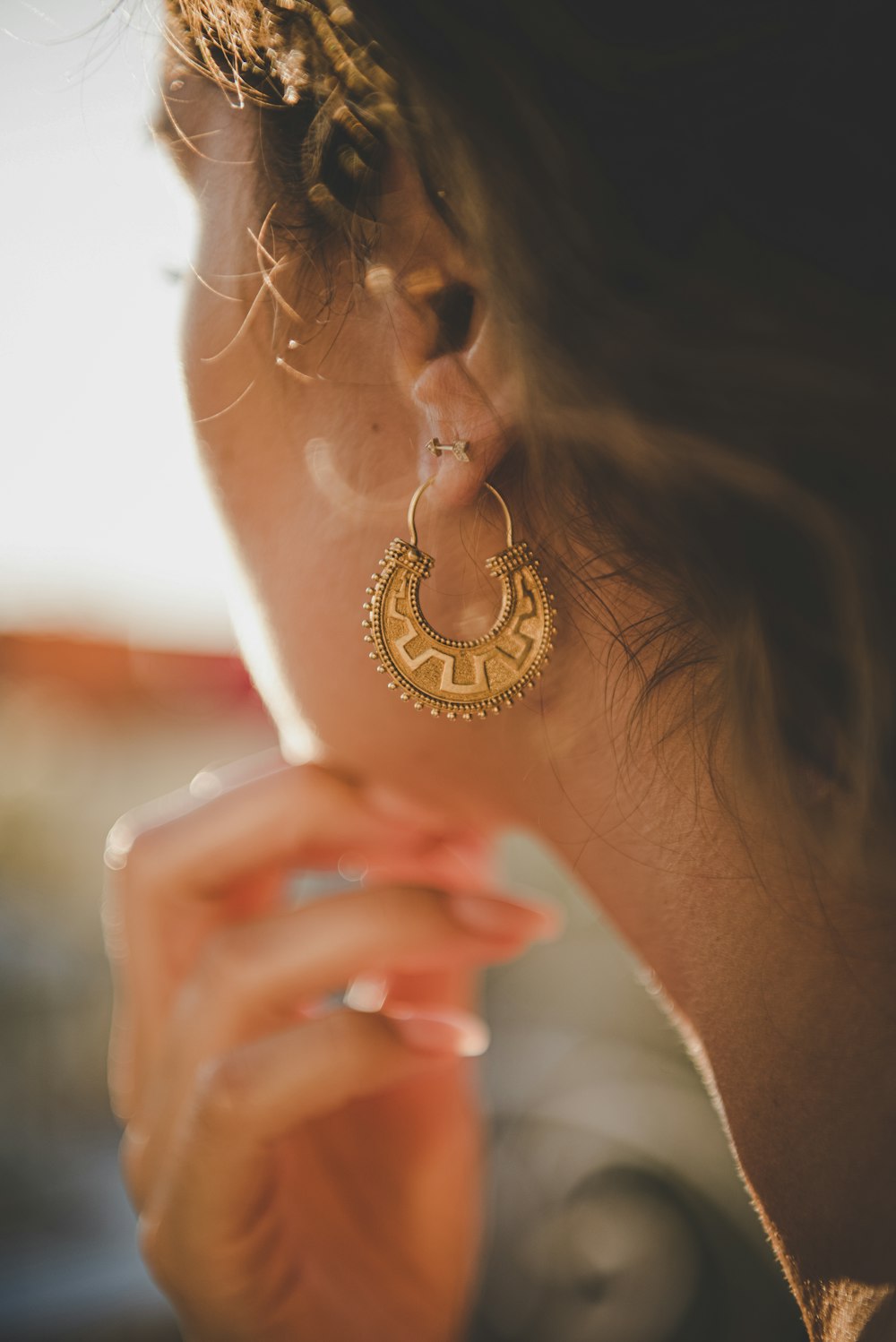 a close up of a person wearing a pair of earrings