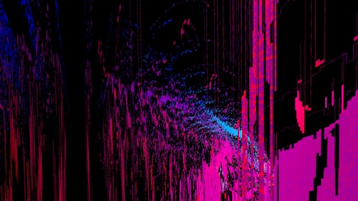 An abstract digital artwork featuring vibrant streaks and splashes of pink, blue, and purple against a predominantly black background. The pattern resembles a chaotic yet structured accumulation of vertical lines and scattered pixels, creating a vivid sense of movement and depth.