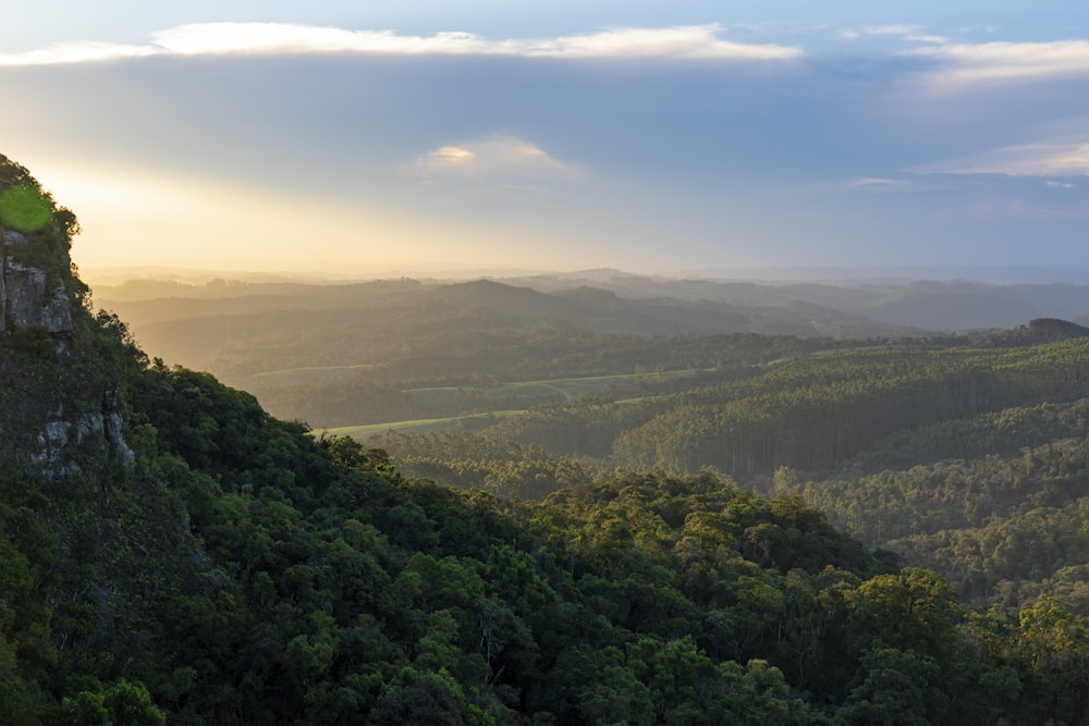 the sun is setting over the mountains in the distance