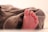 Close-up of a toddler wearing brown low-top soft sole oxfords, taking first steps on a wooden floor.