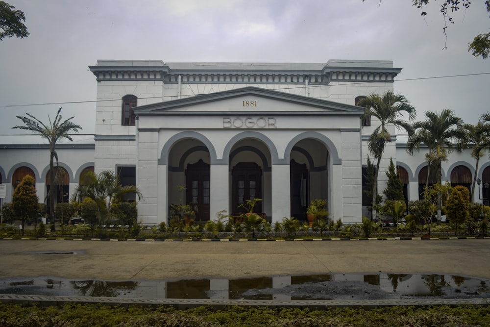 a large white building with a fountain in front of it