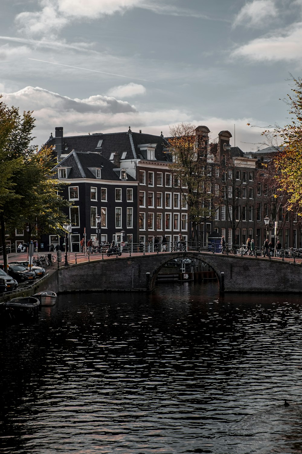 a bridge over a body of water with buildings in the background