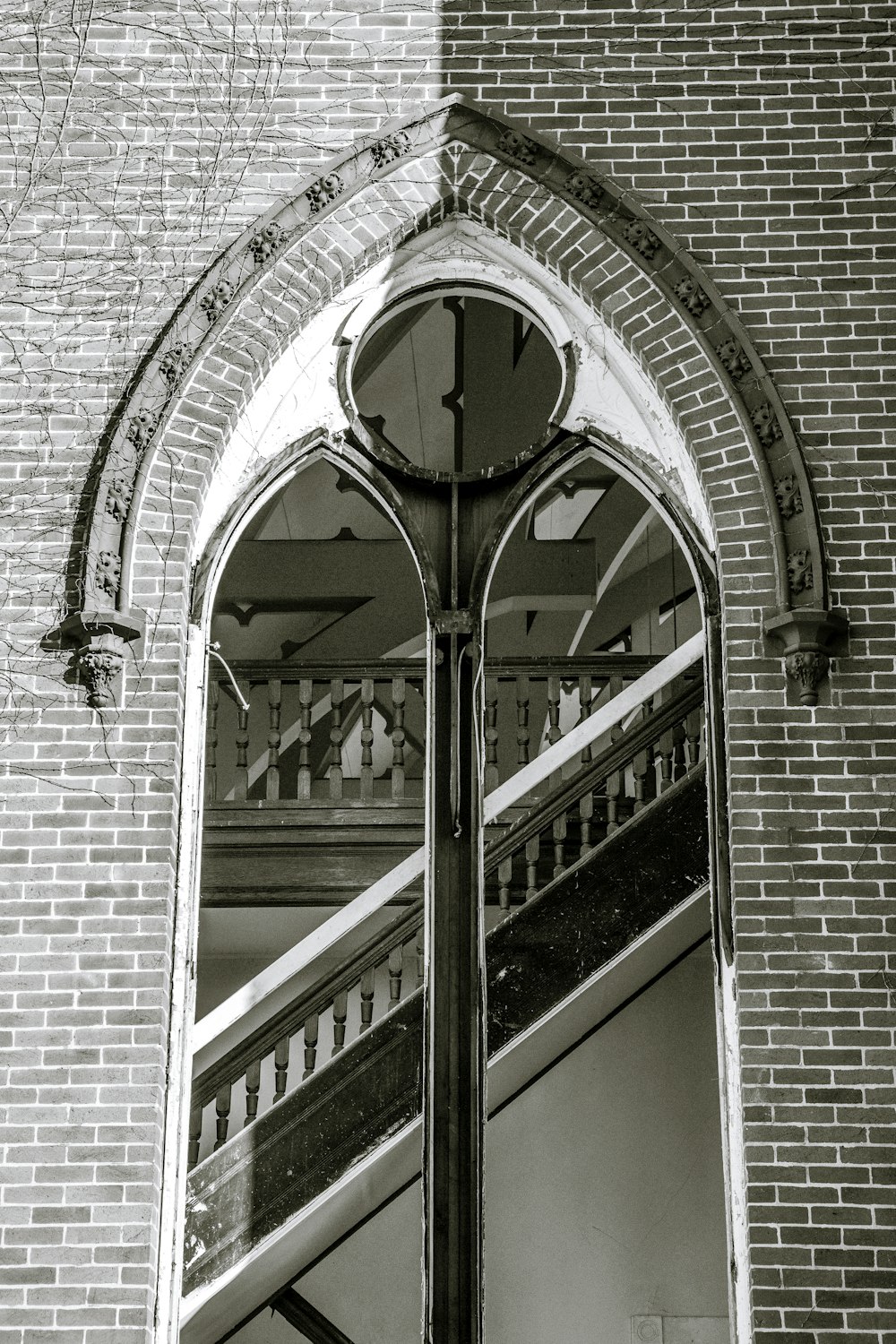 a black and white photo of a clock on the side of a building