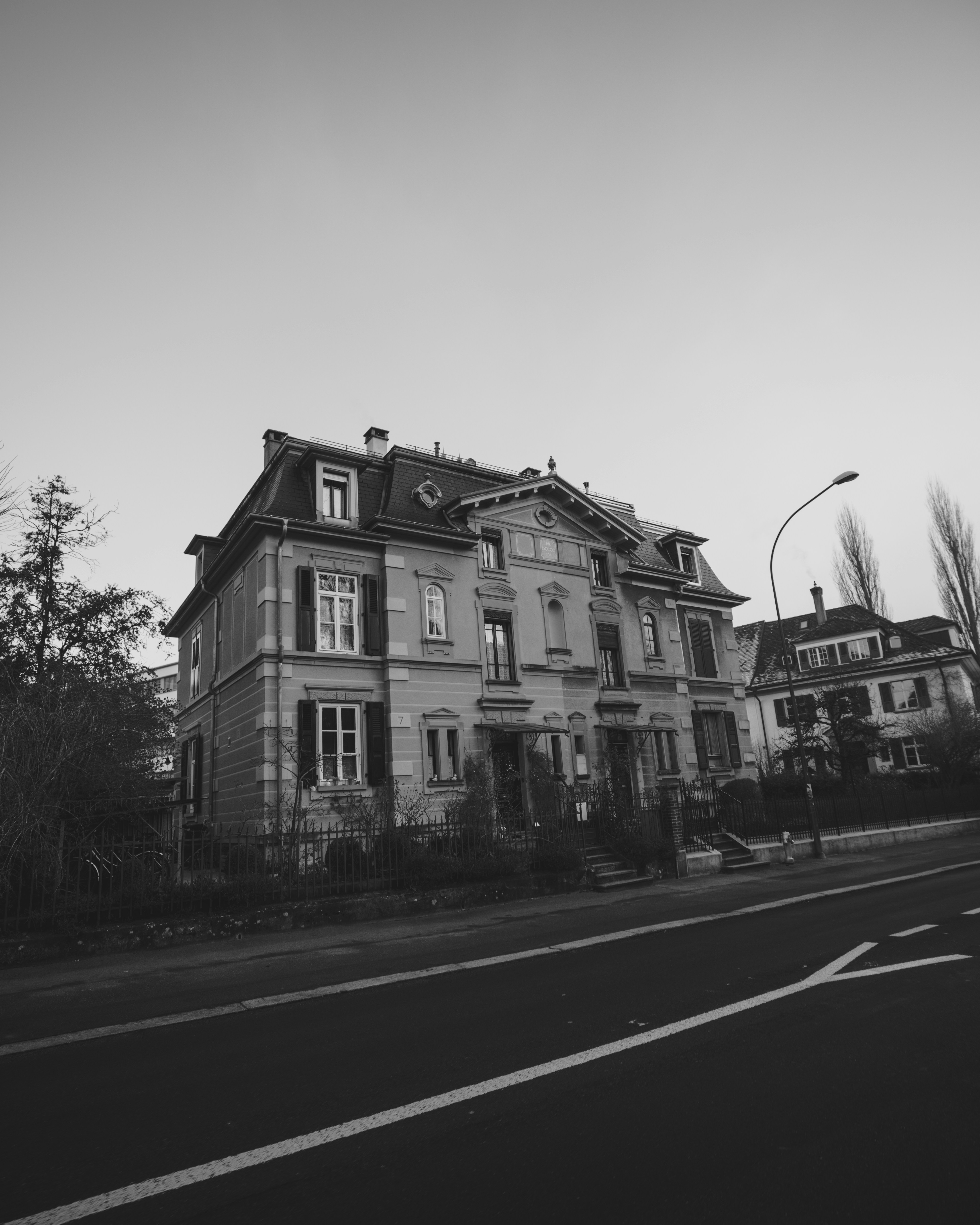 a black and white photo of a large house