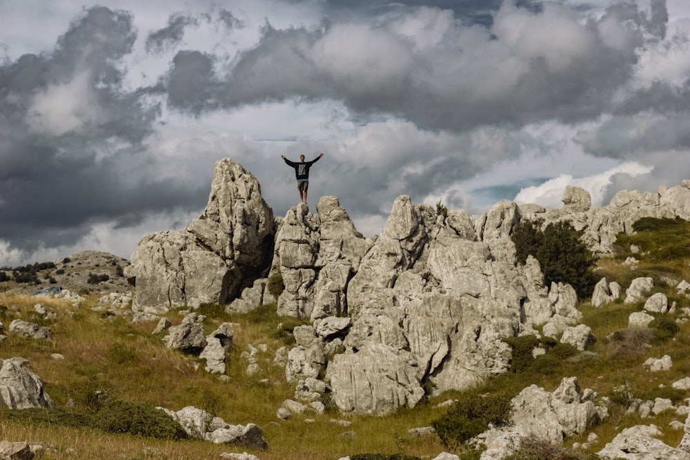 a person standing on top of a rocky hill
