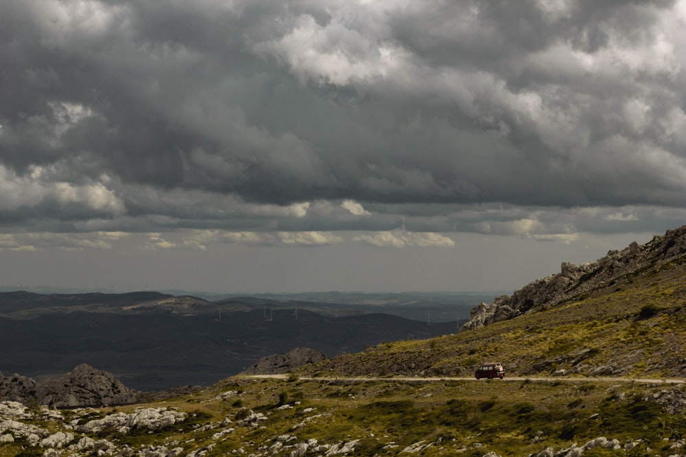 a car driving down a road on a cloudy day