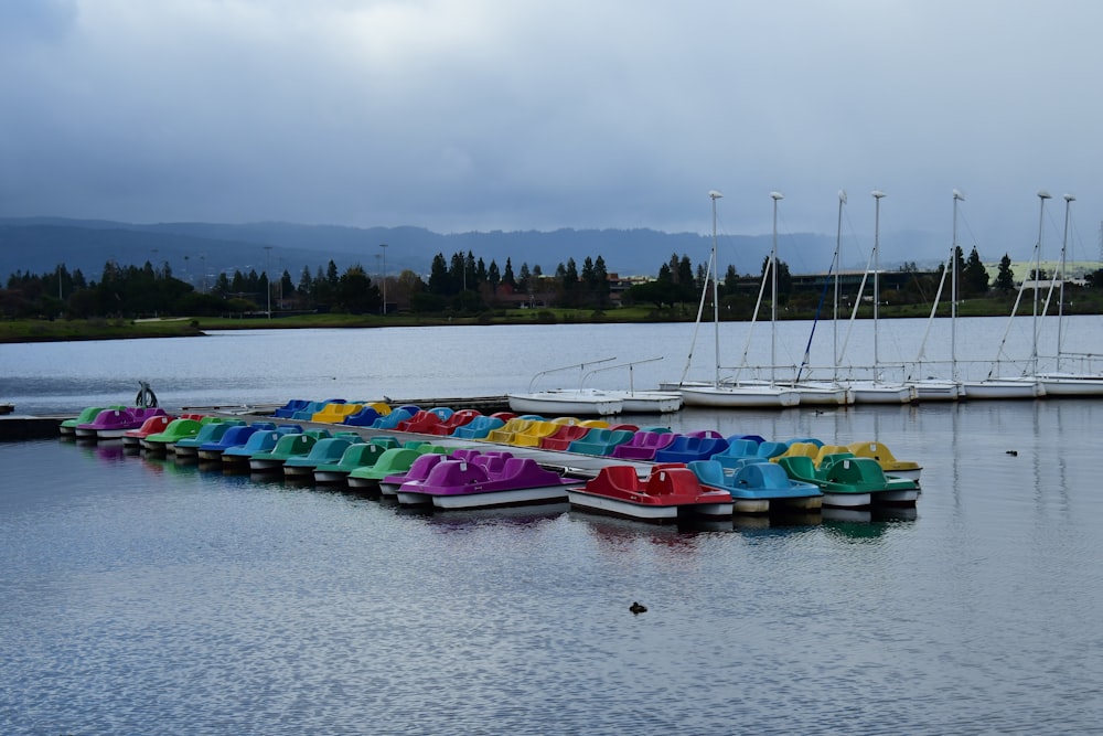 a row of colorful boats sitting on top of a body of water