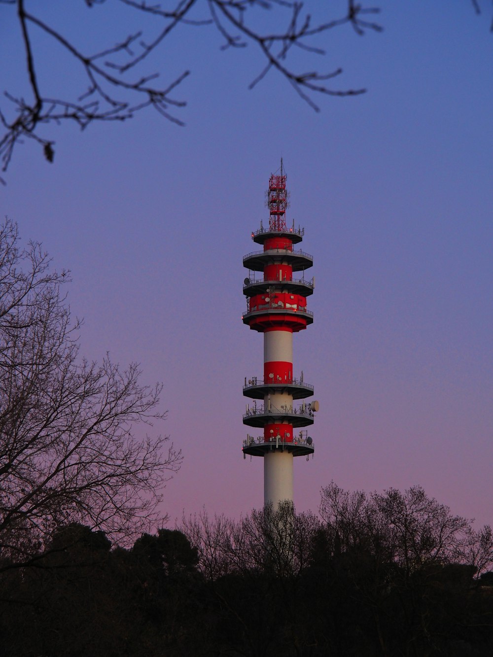 a tall tower with a red and white top