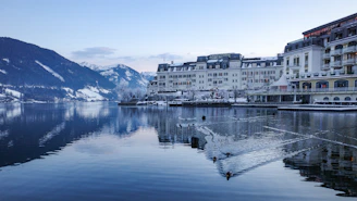 a large body of water surrounded by snow covered mountains