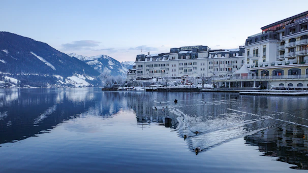 a large body of water surrounded by snow covered mountains