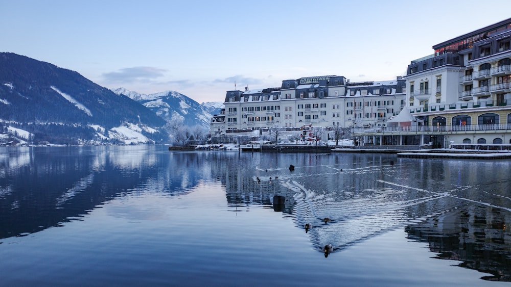 a large body of water surrounded by snow covered mountains