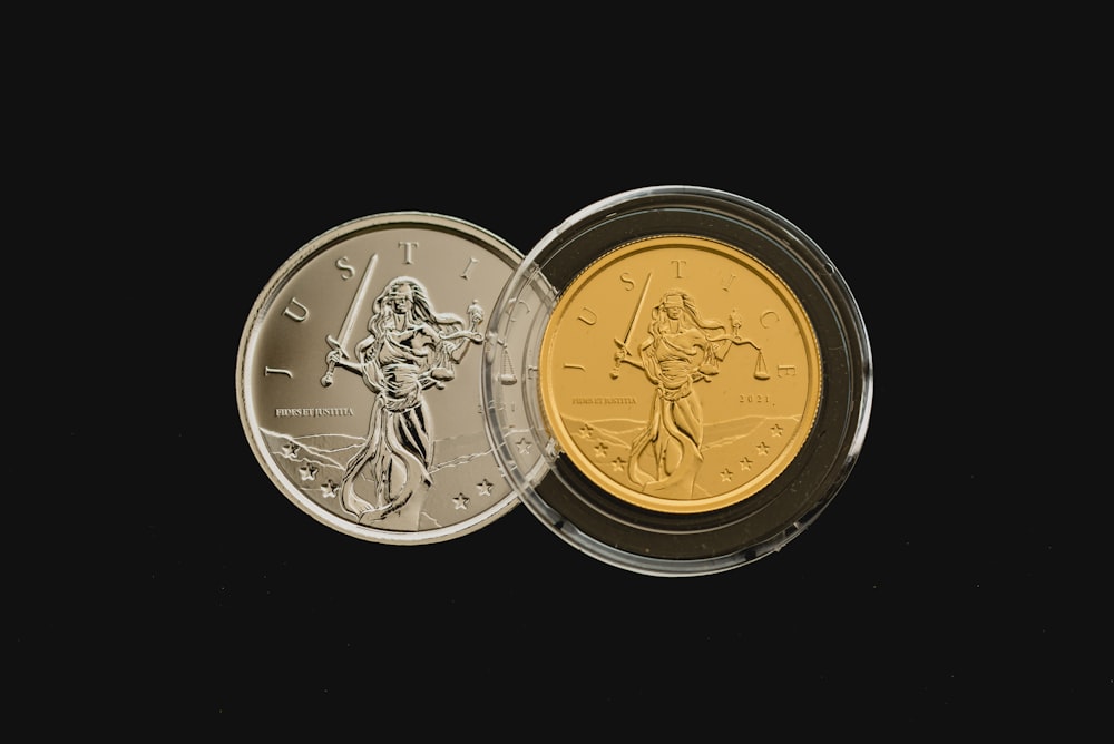 a gold and silver coin on a black background