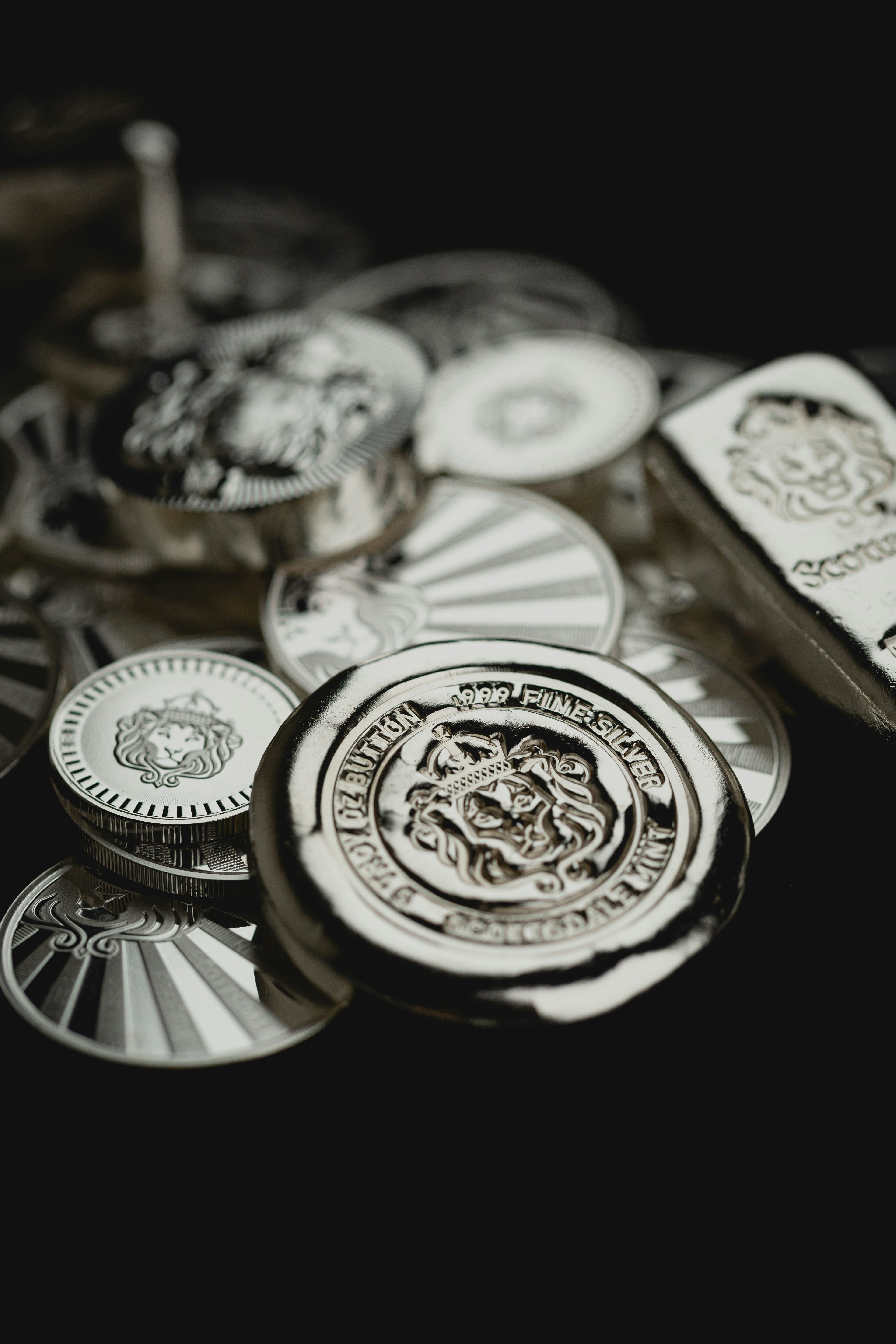 Scottsdale Silver stack of coins, rounds and bars sitting on a dark background. Please give a shoutout to Scottsdale Mint if able! Shop online for the most beautiful bullion at ScottsdaleMint.com!