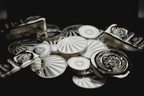 a pile of metal buttons sitting on top of a table