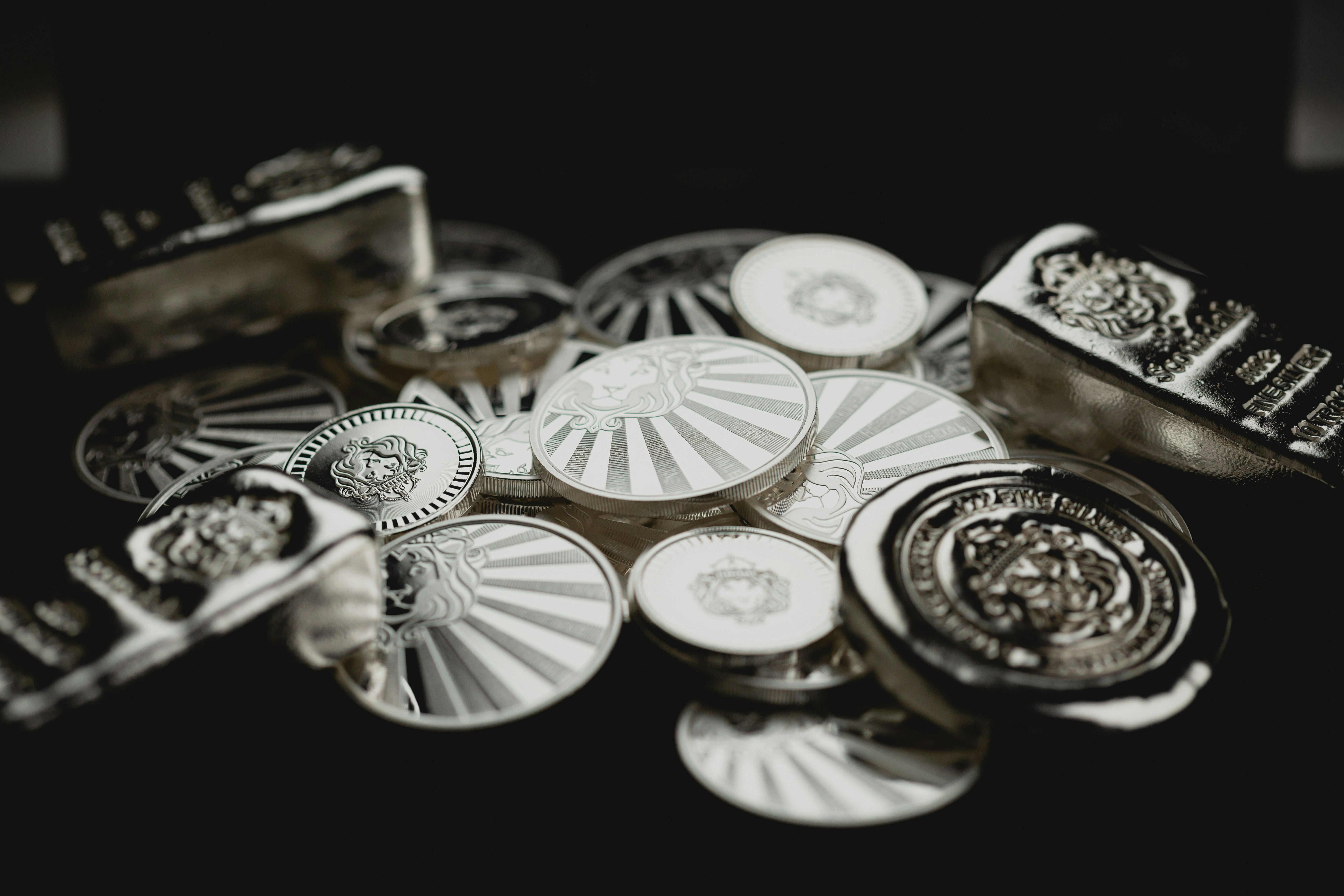 Scottsdale Silver stack of coins, rounds and bars sitting in a pile on a dark background. </p><p dir=
