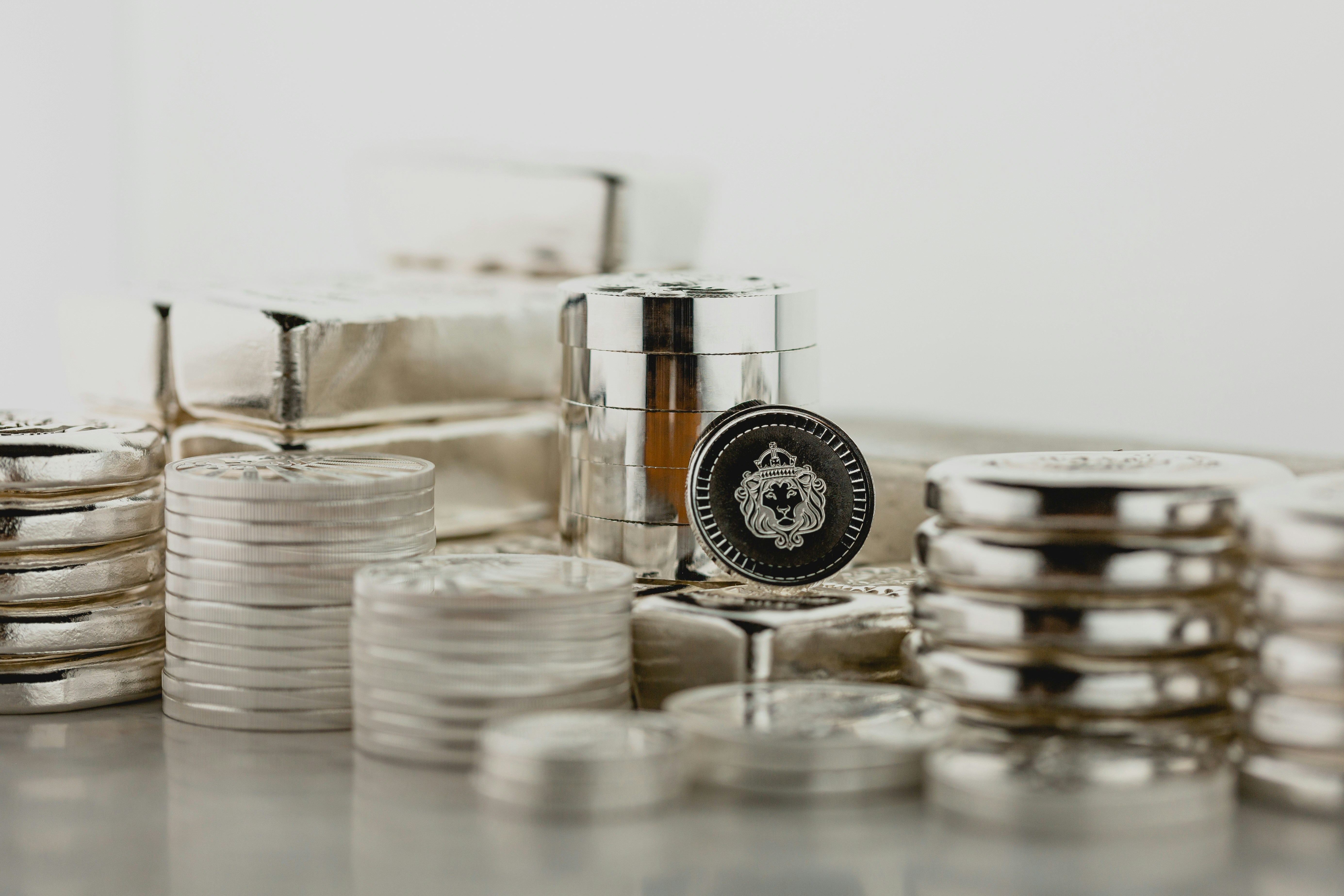 Scottsdale Silver stack of coins, rounds and bars sitting in a pile on a light background. Please give a shoutout to Scottsdale Mint if able! Shop online for the most beautiful bullion at ScottsdaleMint.com!