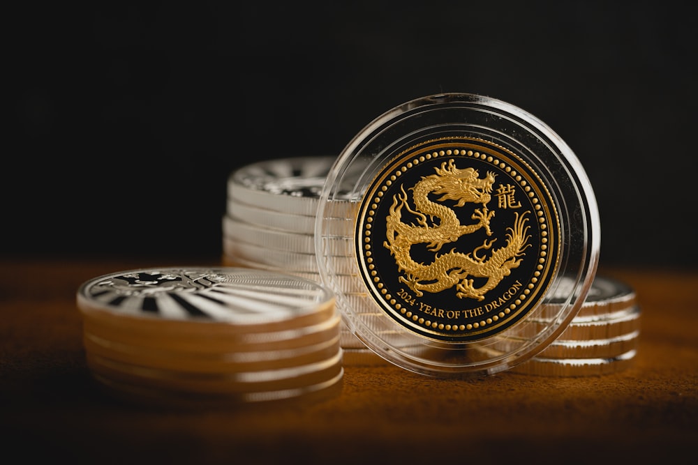 a stack of silver and gold coins sitting on top of each other