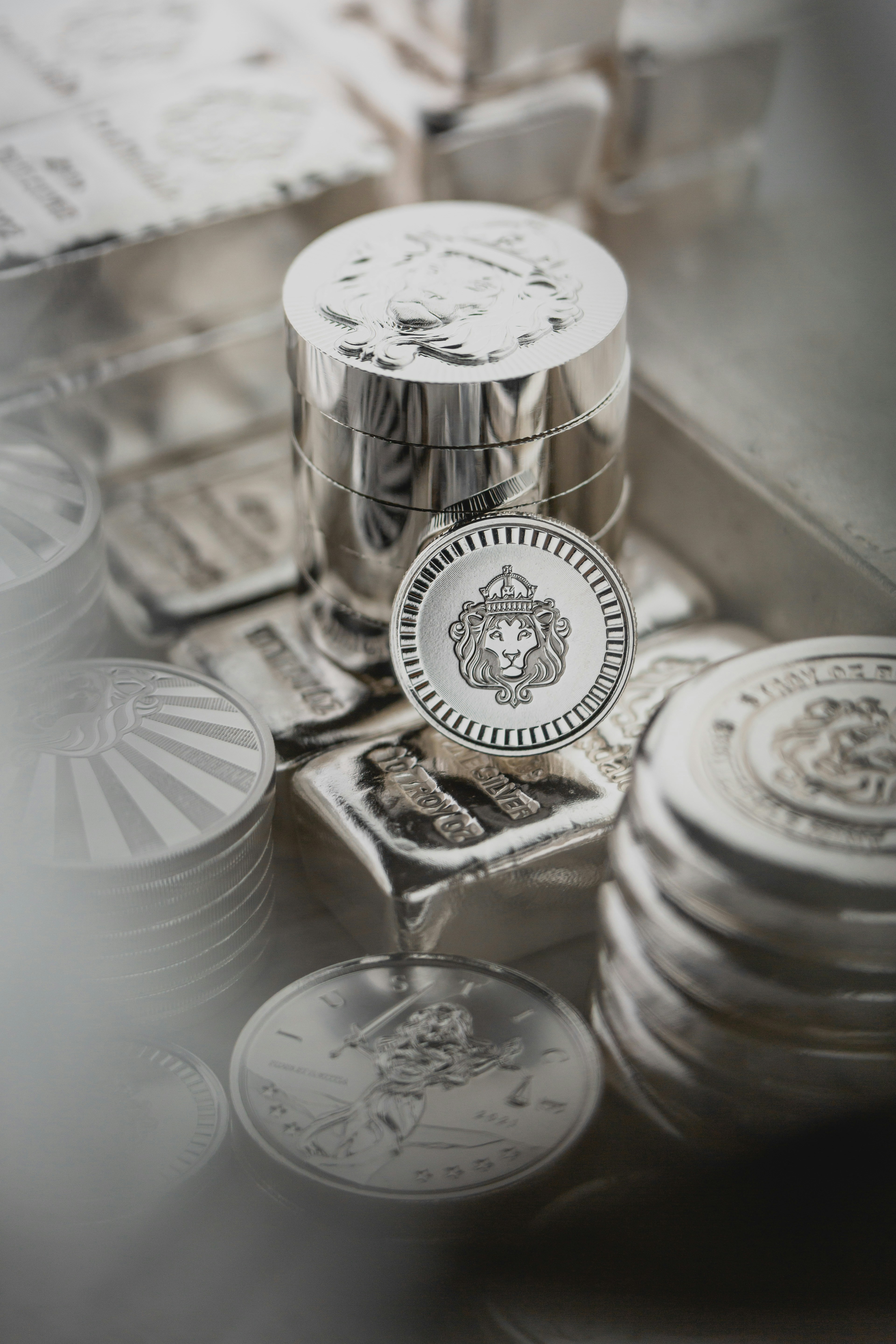 Scottsdale Silver stack of coins, rounds and bars sitting in a pile on a light background. Please give a shoutout to Scottsdale Mint if able! Shop online for the most beautiful bullion at ScottsdaleMint.com!