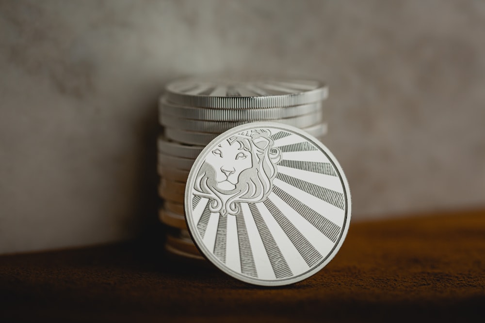 a stack of coins sitting on top of a wooden table