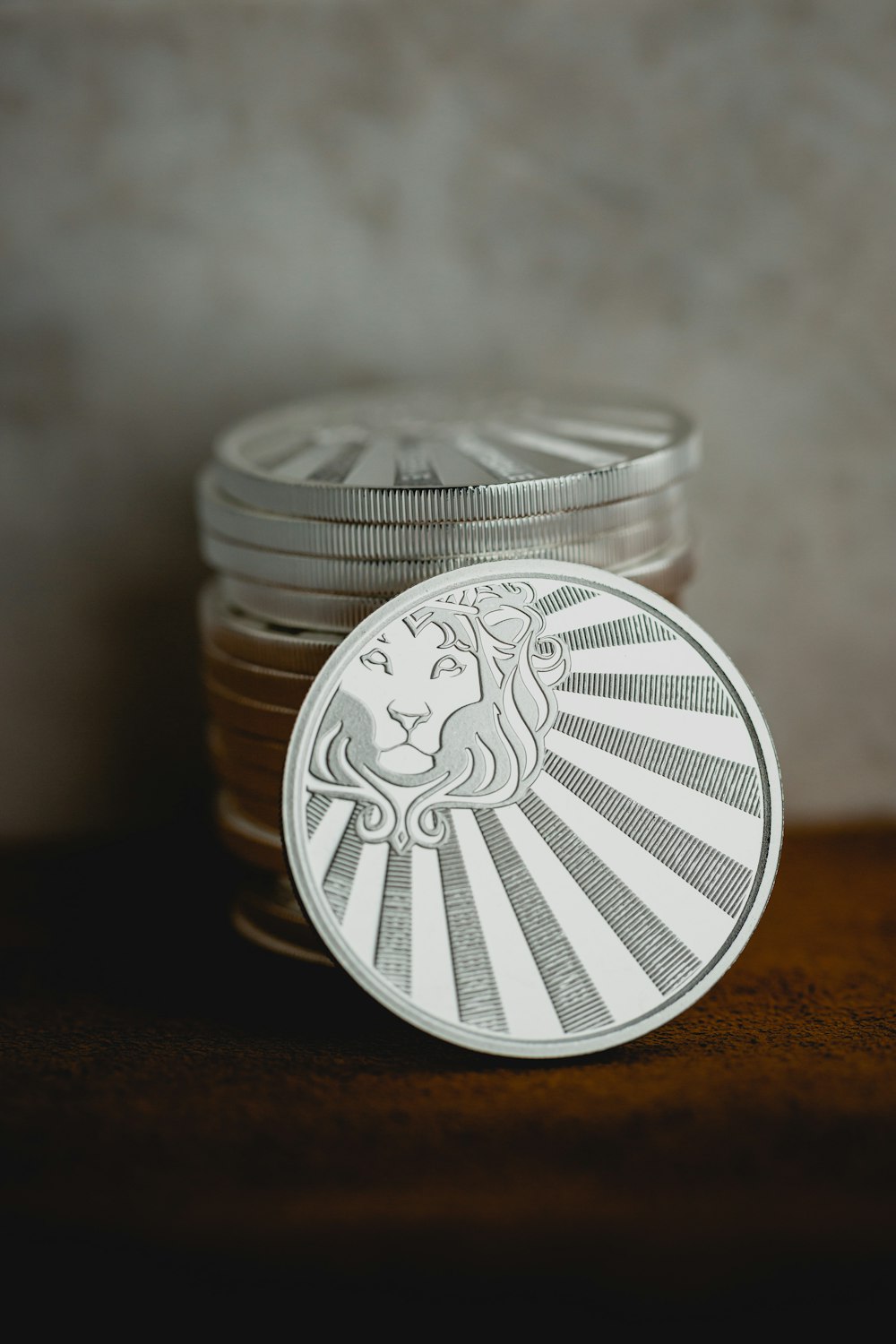 a stack of coins sitting on top of a wooden table