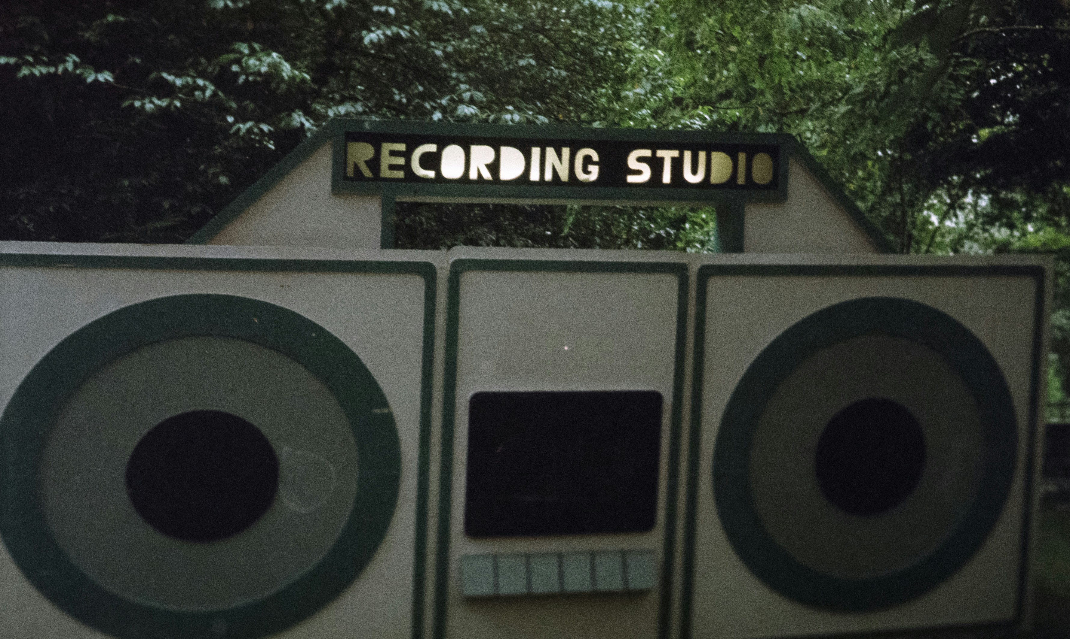 a recording studio with two speakers in front of it