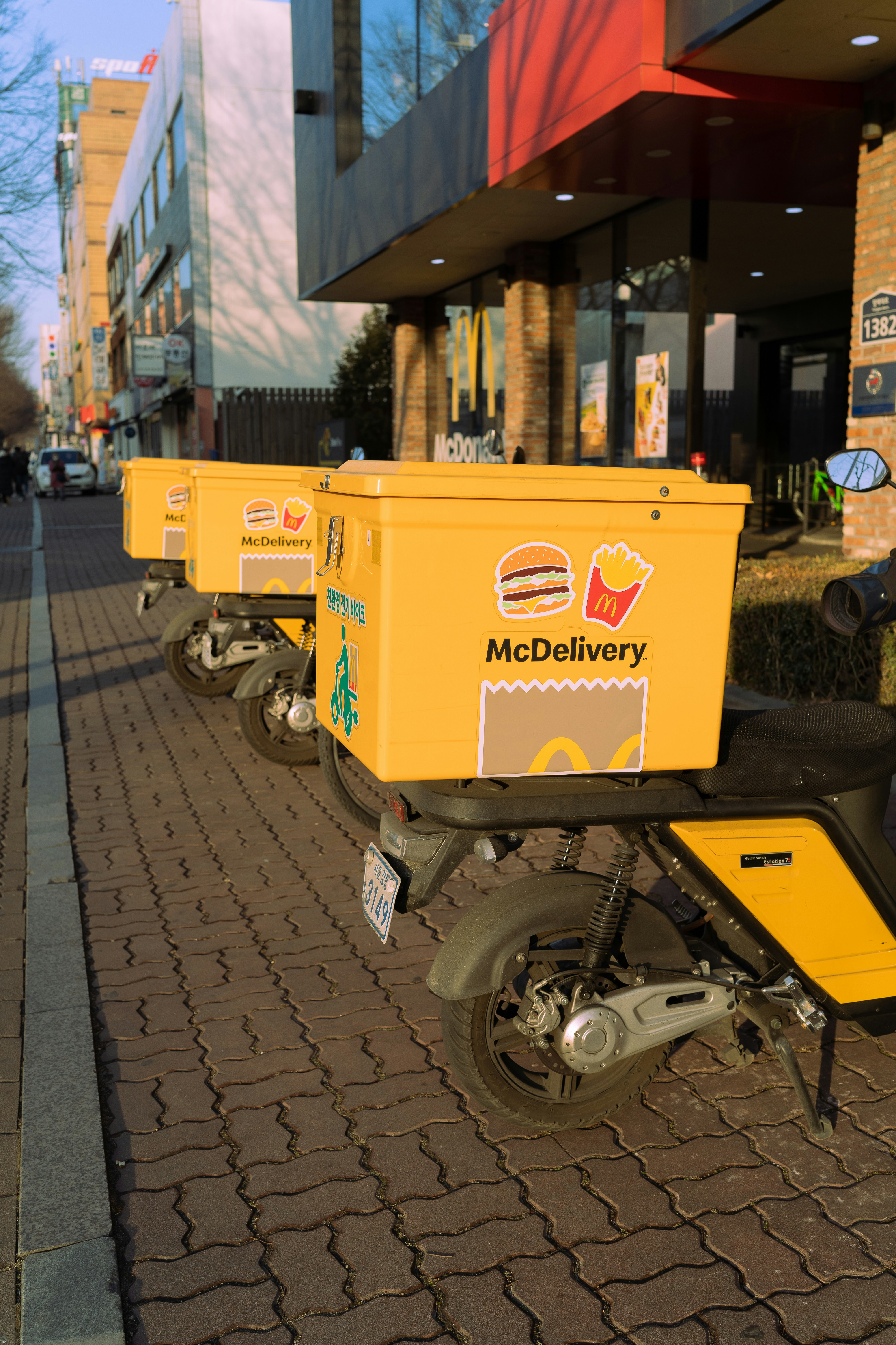 a row of yellow boxes sitting on the side of a road
