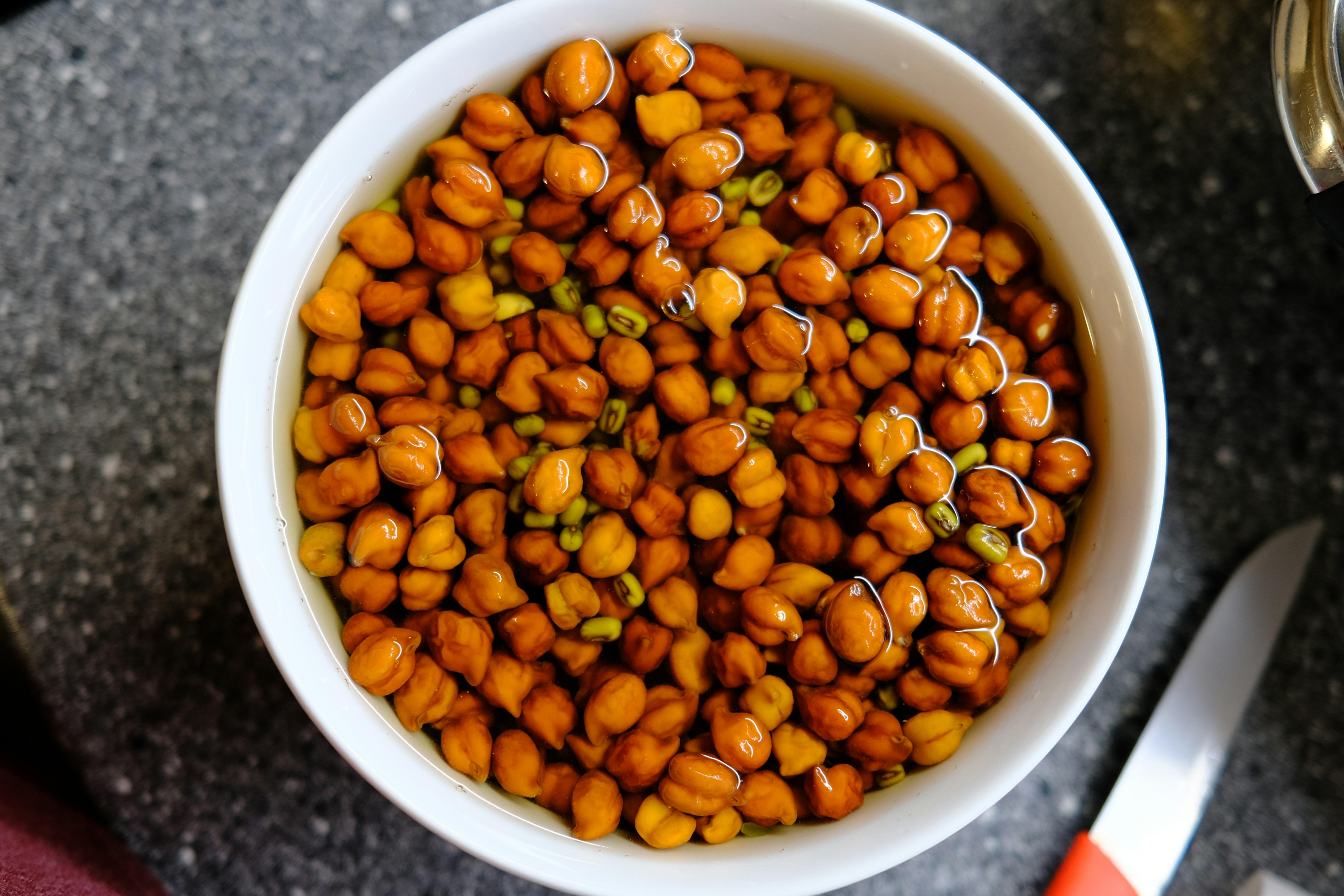 a white bowl filled with beans on top of a table