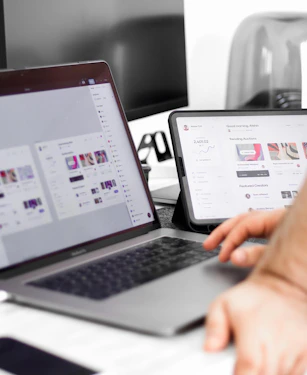 a person sitting at a desk with a laptop