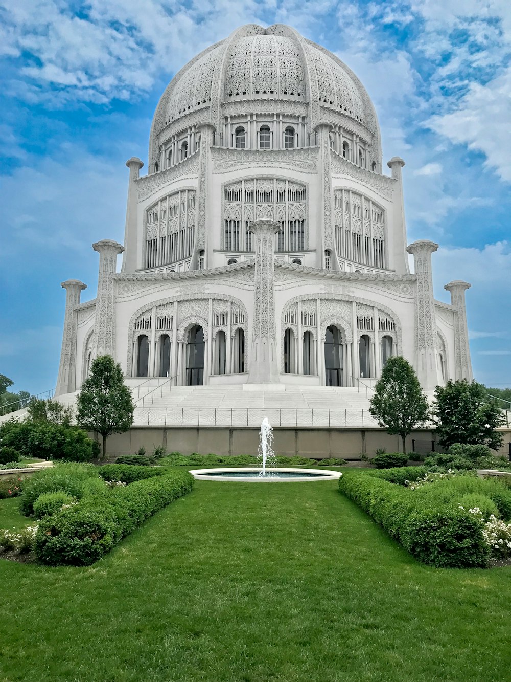 a large white building with a fountain in front of it