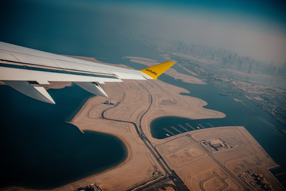 the wing of an airplane flying over a large body of water