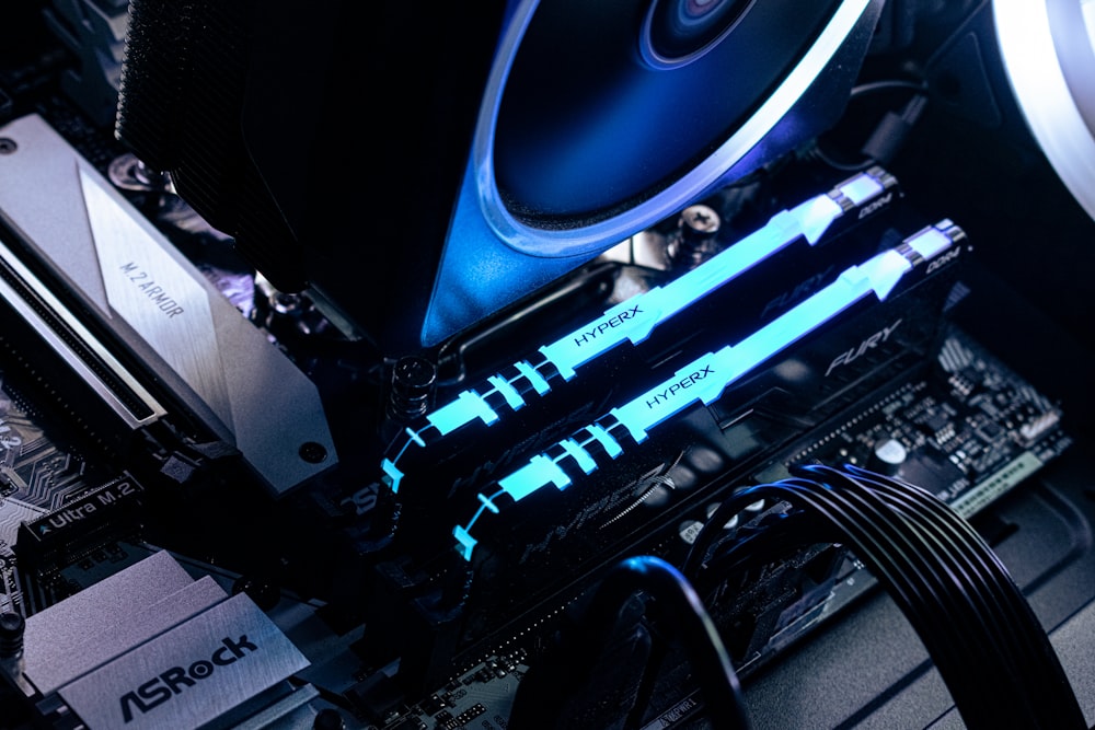 a close up of a computer motherboard with blue lights