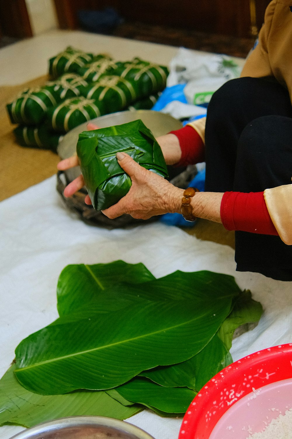 a woman is peeling a leaf of a plant