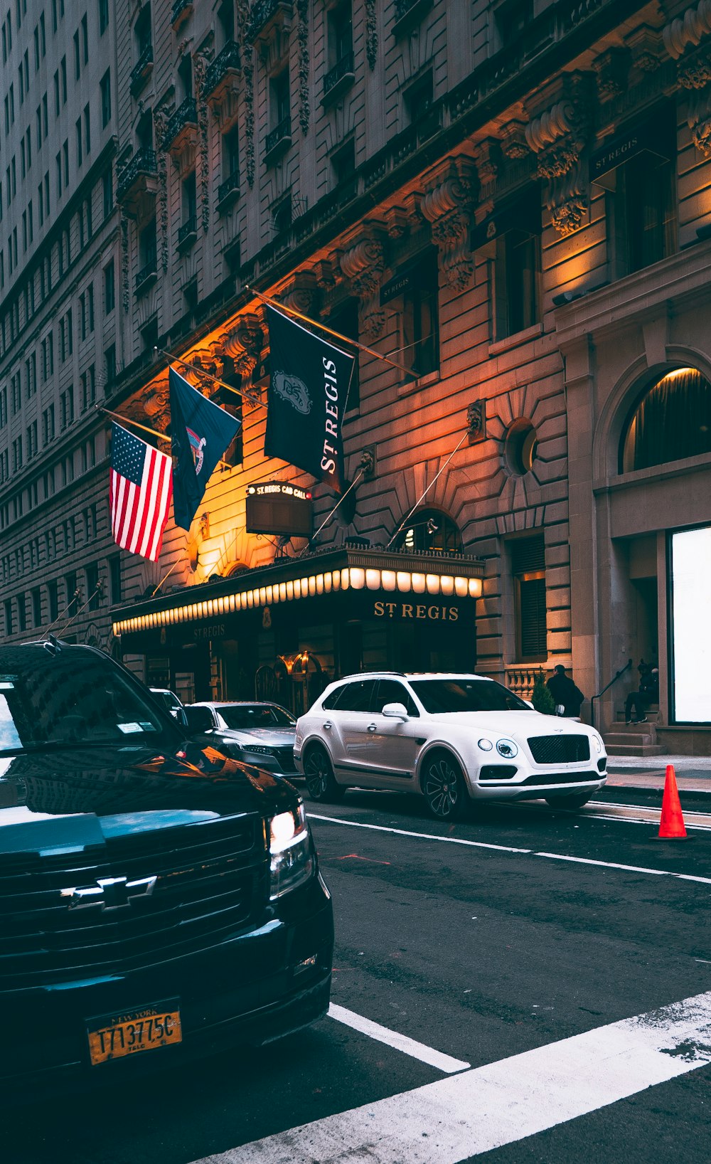 a city street filled with traffic next to tall buildings