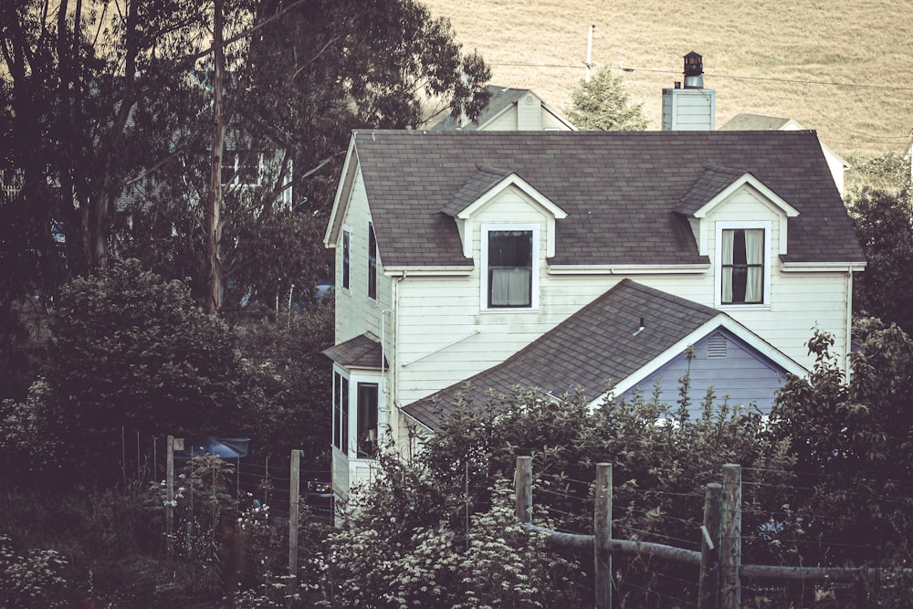 a large white house with a black roof