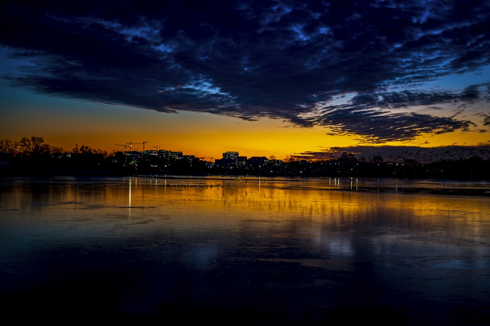 a body of water with a city in the background