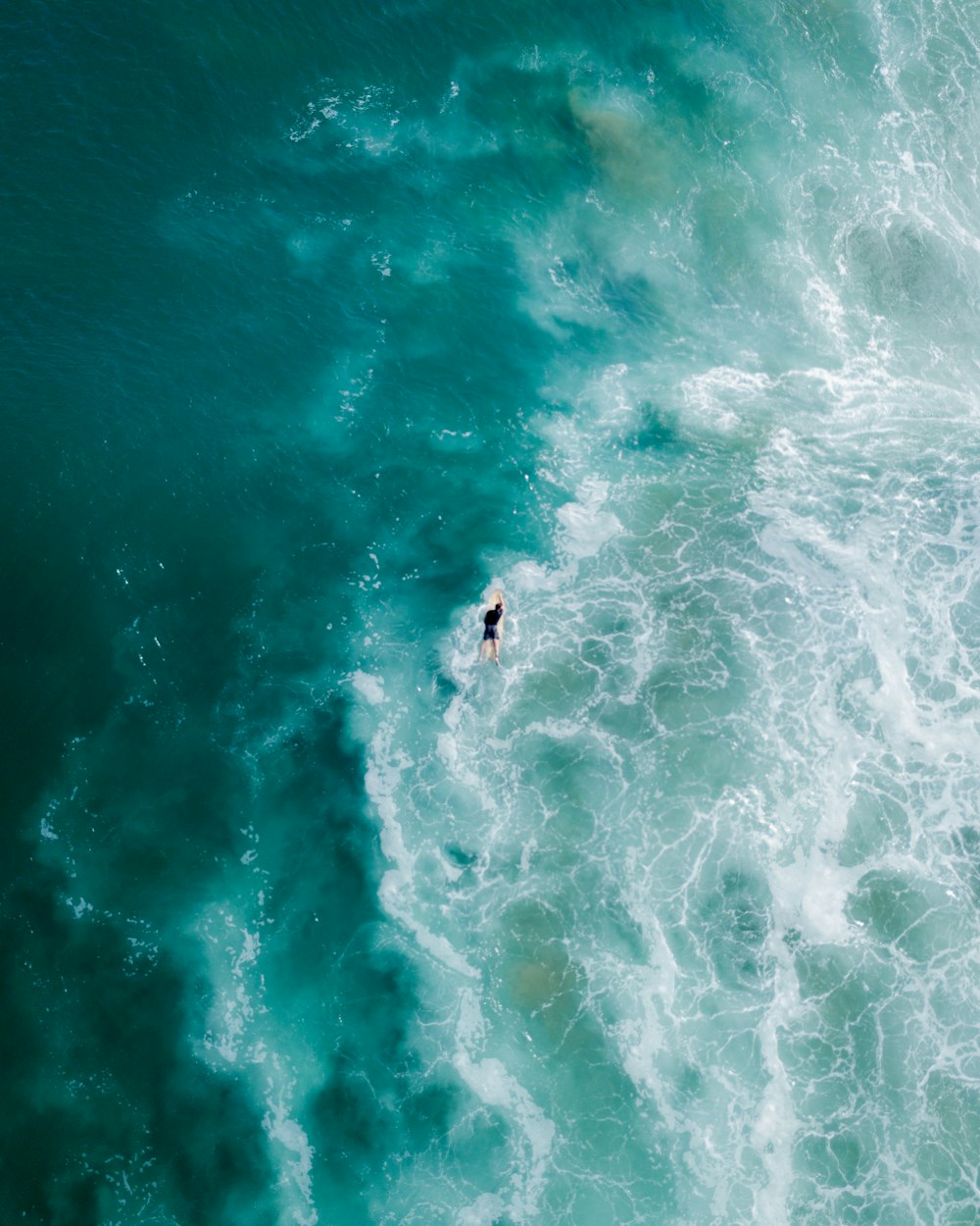 a person riding a surfboard on a wave in the ocean