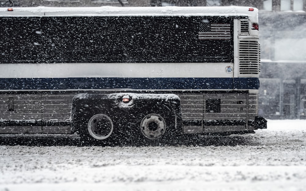 a bus driving down a snow covered street