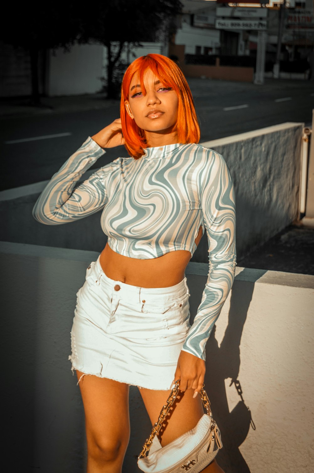 a woman with orange hair is posing for a picture