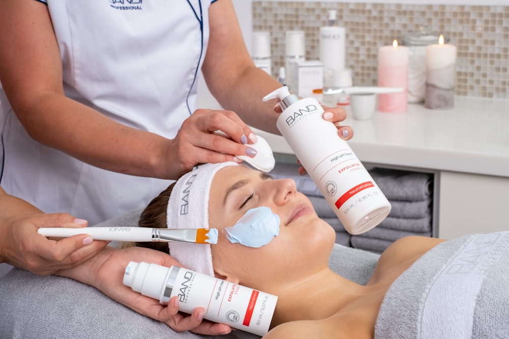 a woman getting a facial mask on her face