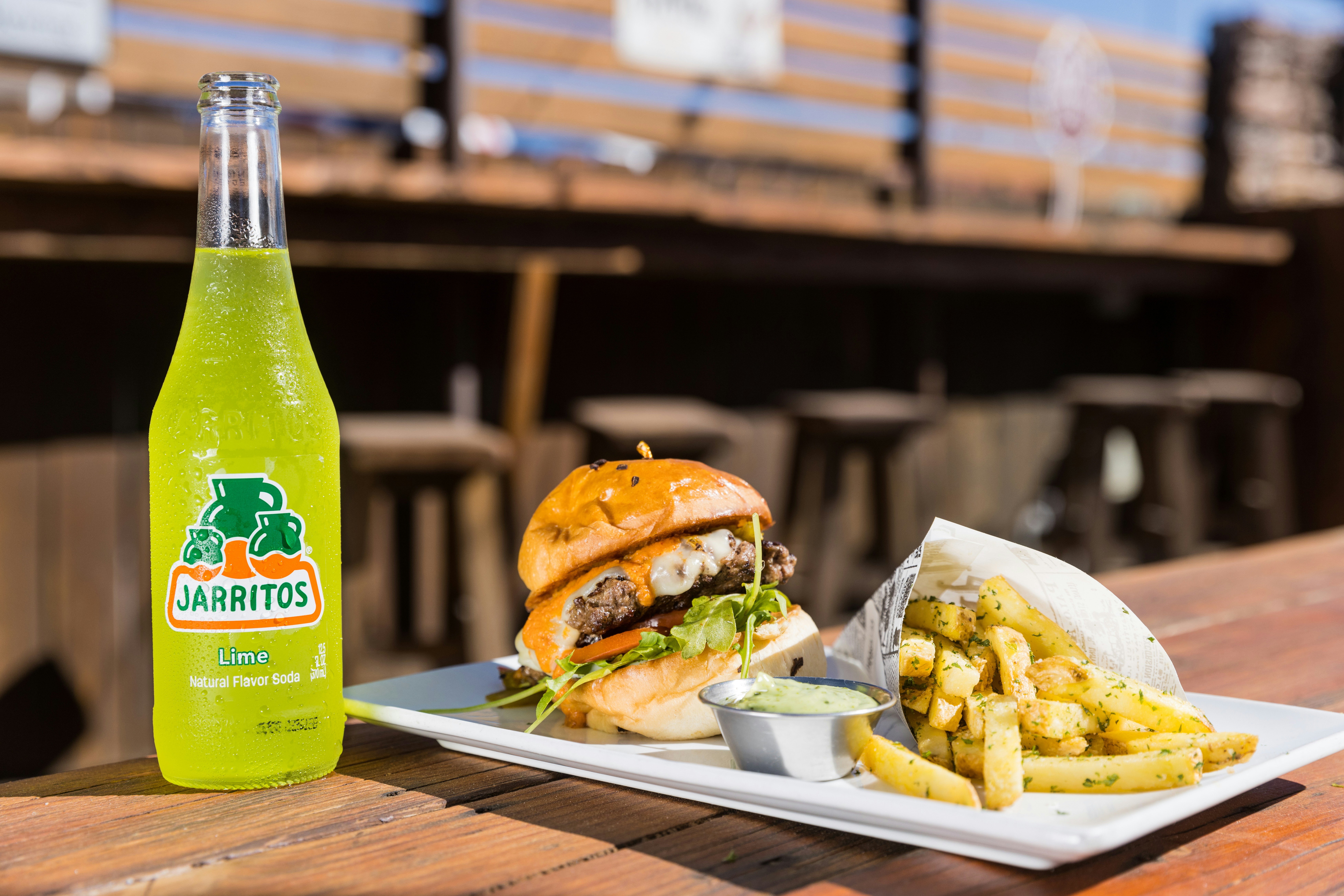 a plate of food and a bottle of beer on a table