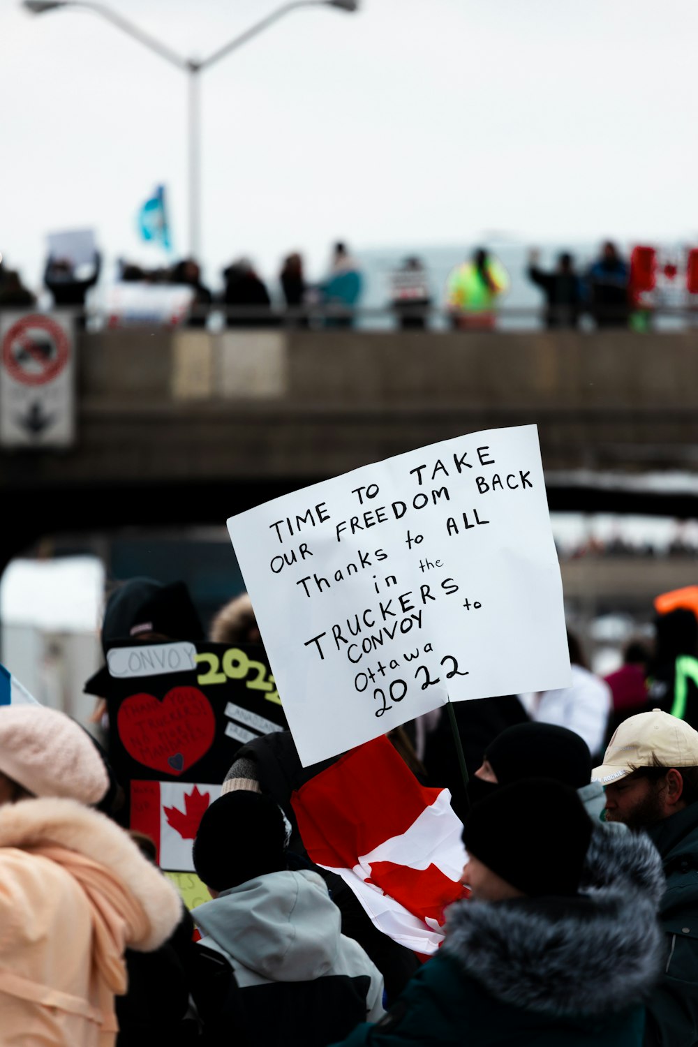 a group of people holding a sign that says time to take our freedom back