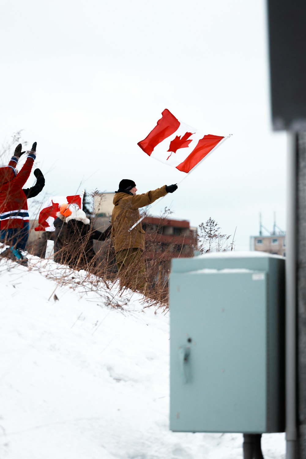 a group of people flying kites in the snow