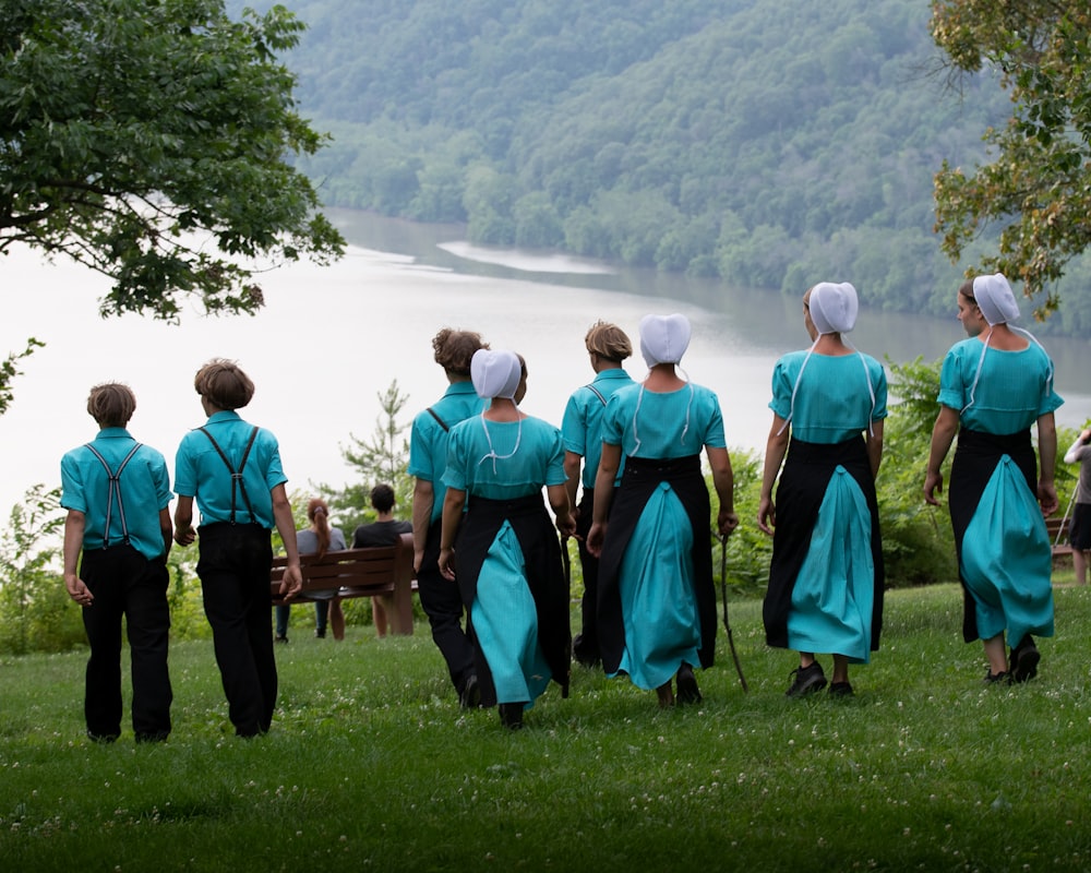 a group of women in blue dresses standing next to each other