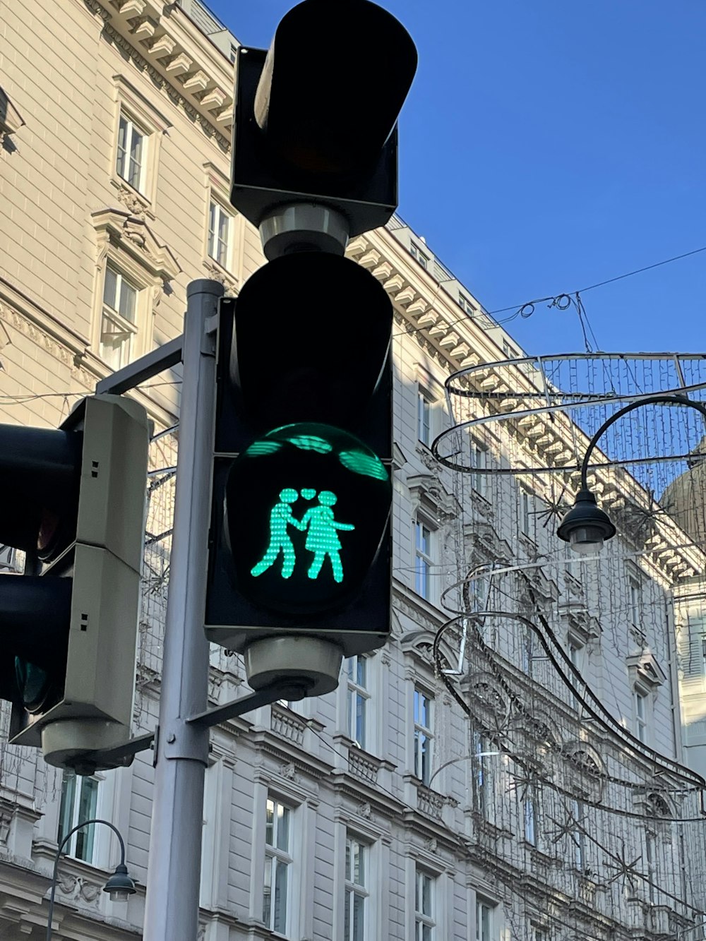 a traffic light with a green pedestrian crossing signal