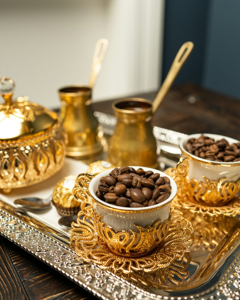 a tray topped with bowls filled with coffee beans